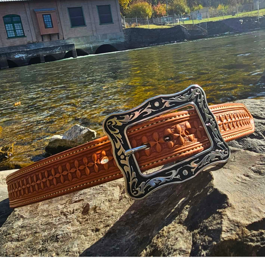 Miles City hand-stamped russet leather belt with silver western buckle by a river