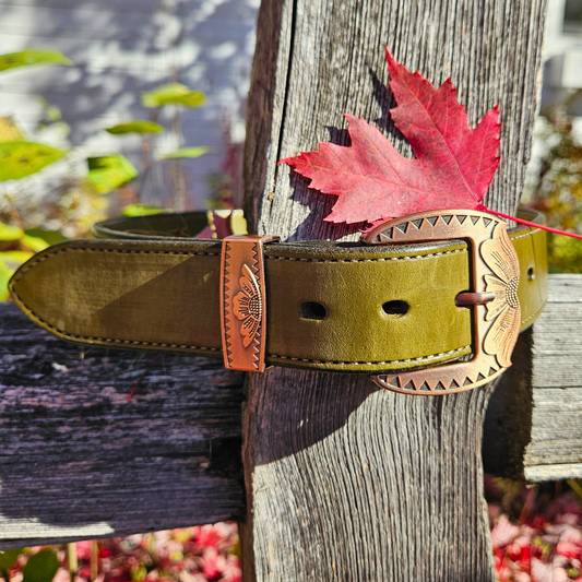 Sun Prairie green handmade leather belt with antique copper buckle on a fence post
