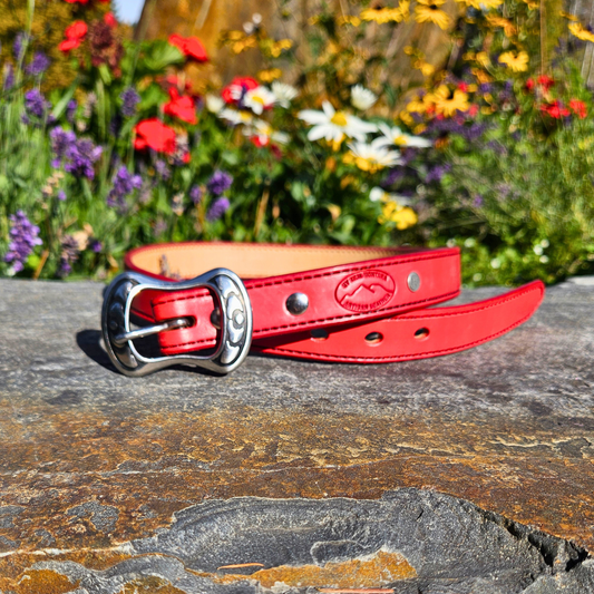 Vermillion River red handmade leather belt with stainless Jeremiah Watt buckle on a rock